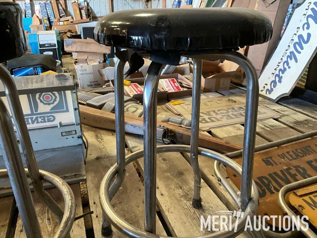 Goodwrench and Chevy bar stools, wooden coffee table, masking tape