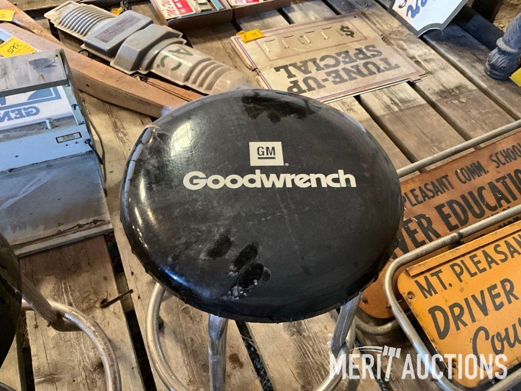Goodwrench and Chevy bar stools, wooden coffee table, masking tape