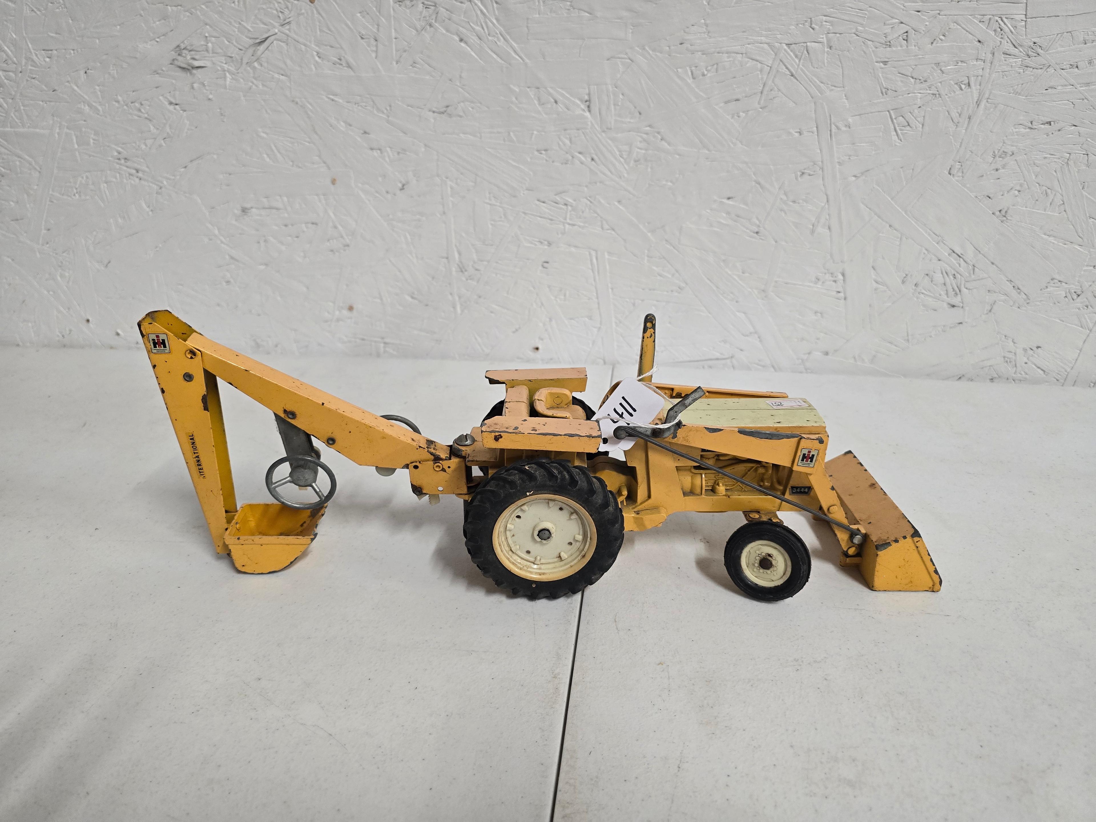 IH backhoe 3444 unboxed missing left front wheel unmarked