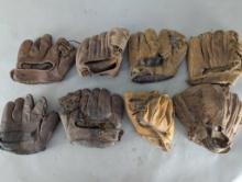 Eight Vintage Baseball Gloves in Various Conditions