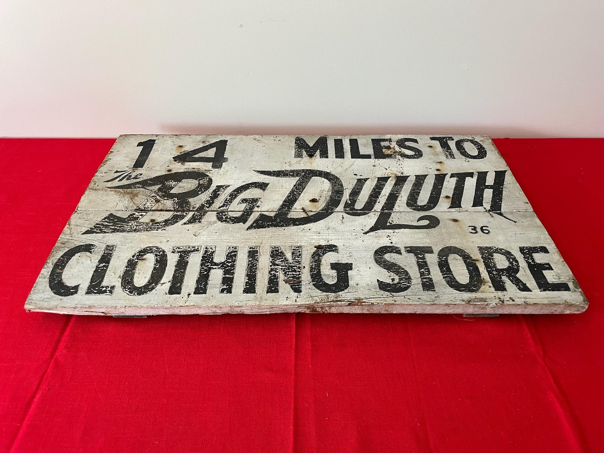 Big Duluth Clothes Wood Road Sign