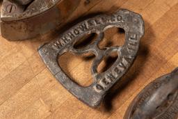 Three Antique Clothes Irons and Trivet