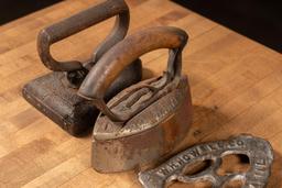 Three Antique Clothes Irons and Trivet