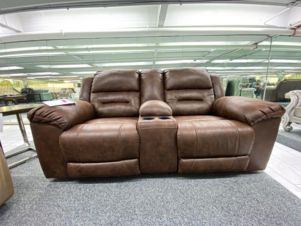 Traditional brown loveseat with electronic recliners and middle storage console, has 2 cupholders