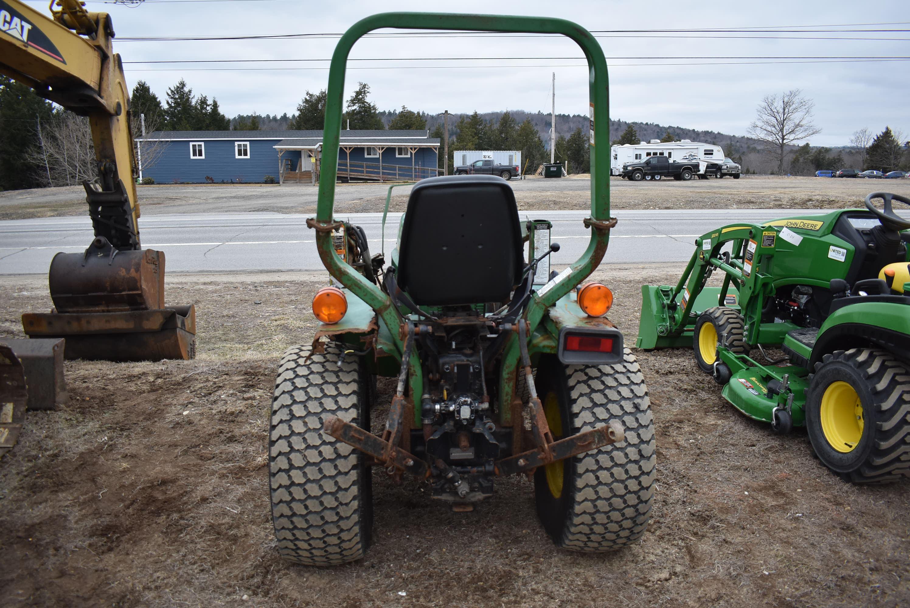 John Deere 775 tractor with bucket