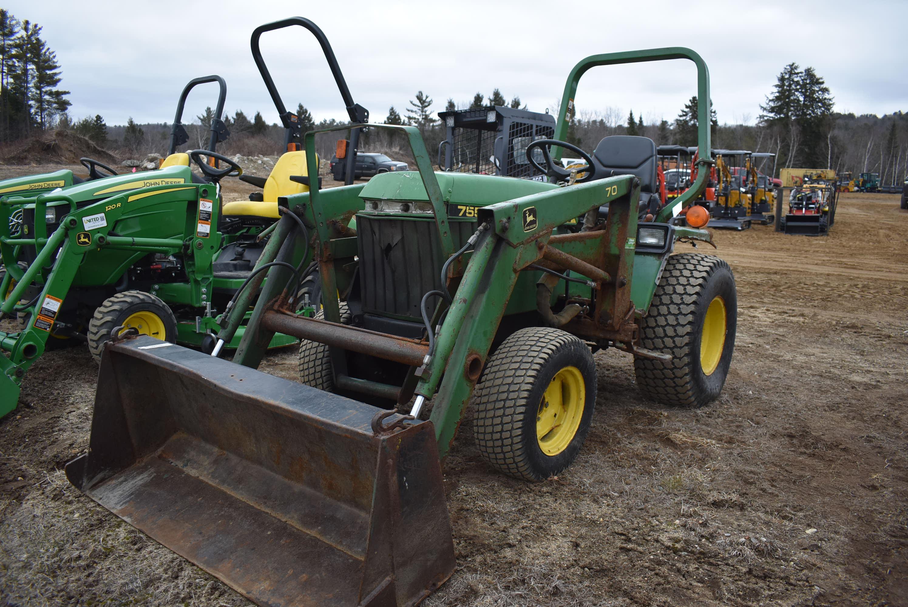 John Deere 775 tractor with bucket