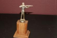 A Metal Statue on Wooden Base