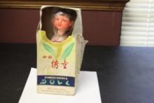 A Vintage Chinese Wooden(?) Doll in Silk Dress