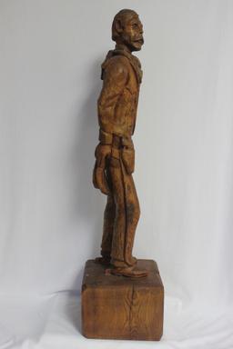 A Wood Statue of a Cowboy