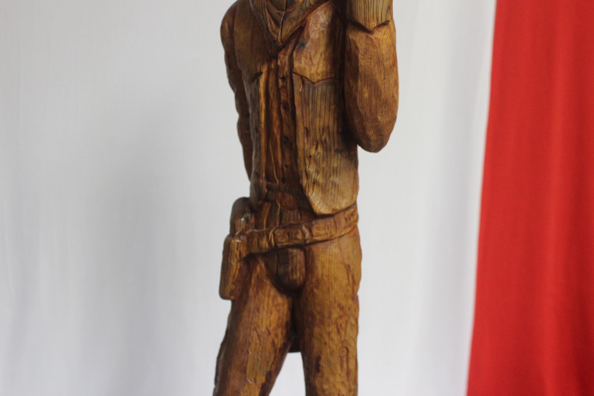 A Wood Statue of a Cowboy