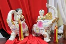 A Boy and Girl on Elephant Statues