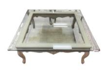 CARVED SOLID WOOD LIGHT-STAINED COFFEE TABLE WITH THICK GLASS BEVELED TOP