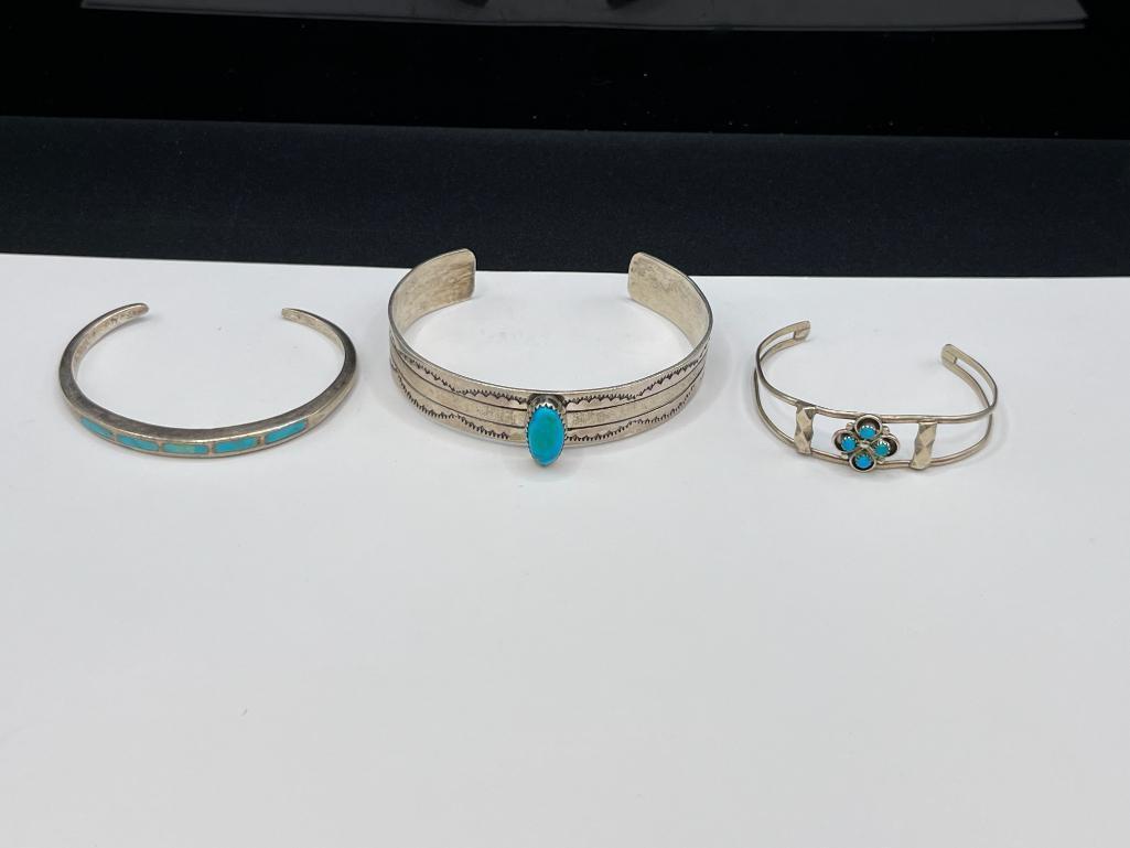 THREE NAVAJO STERLING SILVER TURQUOISE CUFF BRACELET INCLUDING ONE SIGNED BY LARRY BENNETT