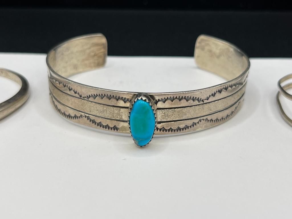 THREE NAVAJO STERLING SILVER TURQUOISE CUFF BRACELET INCLUDING ONE SIGNED BY LARRY BENNETT