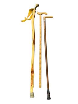 THREE WOOD WALKING STICKS INCLUDING ONE POLISHED PINE WITHG BRASS NOB HANDLE