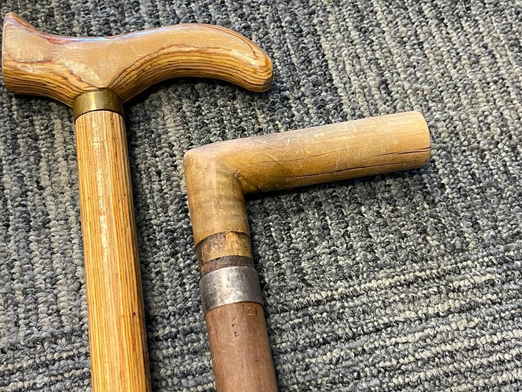 THREE WOOD WALKING STICKS INCLUDING ONE POLISHED PINE WITHG BRASS NOB HANDLE