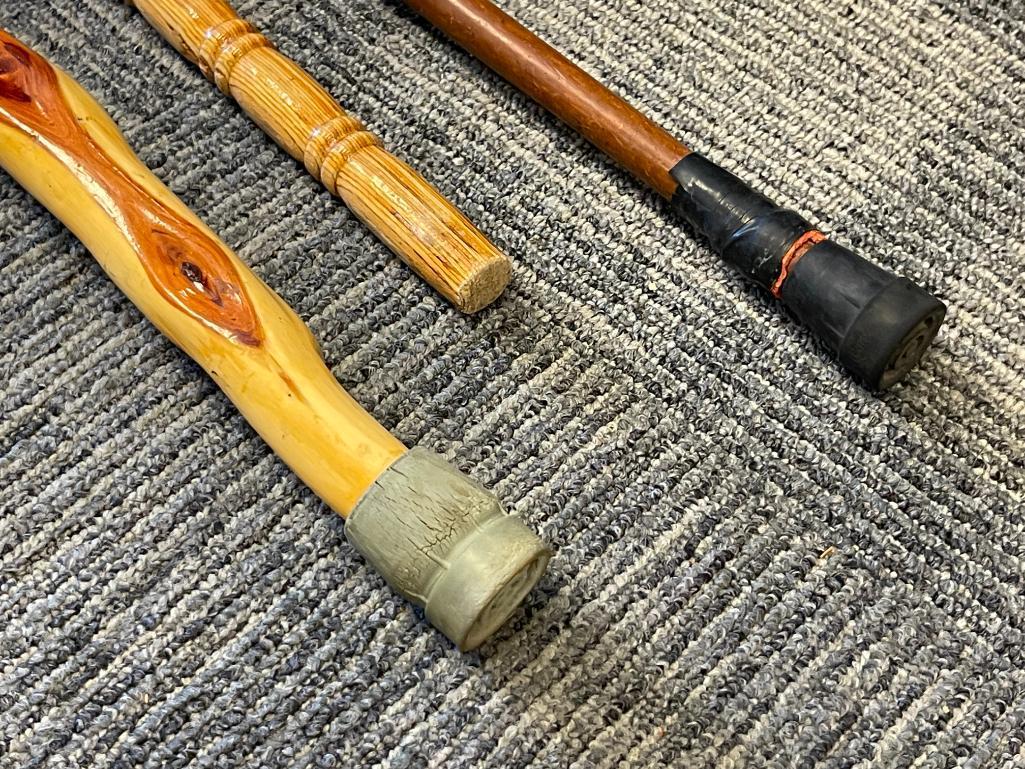 THREE WOOD WALKING STICKS INCLUDING ONE POLISHED PINE WITHG BRASS NOB HANDLE