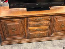 VINTAGE SOLID OAK CONSOLE TABLE FEATURING THREE DRAWERS AND TWO CABINETS