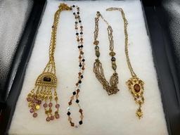 FOUR GOLD TONE STATEMENT NECKLACES INCLUDING THREE VINTAGE, ONE BEADED, AND ONE BY MAYA