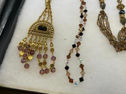 FOUR GOLD TONE STATEMENT NECKLACES INCLUDING THREE VINTAGE, ONE BEADED, AND ONE BY MAYA