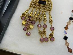 FOUR GOLD TONE STATEMENT NECKLACES INCLUDING THREE VINTAGE, ONE BEADED, AND ONE BY MAYA