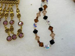 FOUR GOLD TONE STATEMENT NECKLACES INCLUDING THREE VINTAGE, ONE BEADED, AND ONE BY MAYA