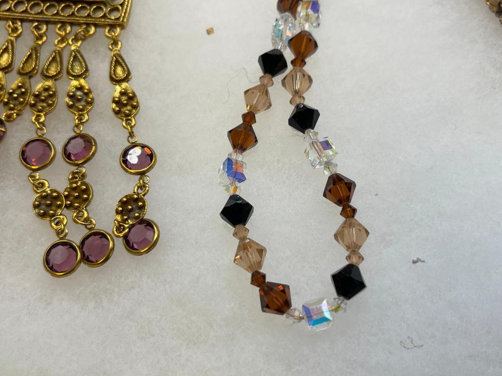 FOUR GOLD TONE STATEMENT NECKLACES INCLUDING THREE VINTAGE, ONE BEADED, AND ONE BY MAYA