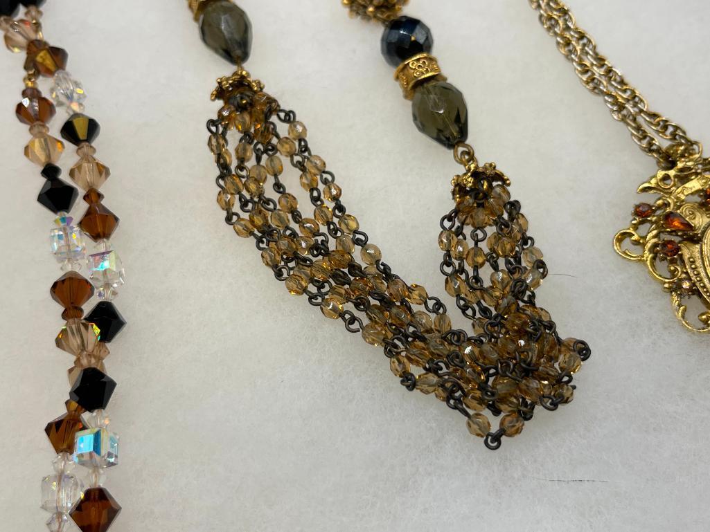 FOUR GOLD TONE STATEMENT NECKLACES INCLUDING THREE VINTAGE, ONE BEADED, AND ONE BY MAYA