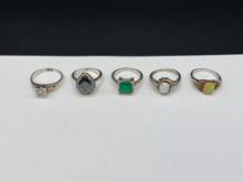 FIVE STERLING SILVER SYNTHETIC STONE RINGS HIGHLIGHTED BY A BLACK HILLS GOLD RING