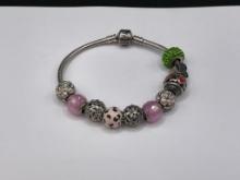 PANDORA STERLING SILVER BRACELET AND CHARMS, HEART MOTIF, "BEST NANA," FLOWERS, AND MORE