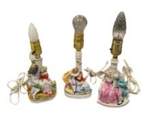 THREE HAND PAINTED PORCELAIN ROMANCE PROVINCIAL FIGURAL BOUDIER TABLE LAMPS, TWO ARE MADE IN GERM...
