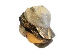 SEVEN BASEBALL STYLE HATS FEATURING MOSTLY CAMOFLAGE AND HUNTING BRANDS