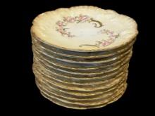 LIMOGES A. LANTERNIER SCALLOPED EDGE DESSERT PLATES WITH FLORAL DESIGN AND HEAVY GILT ACCENTS