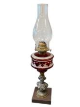 VICTORIAN PERIOD SPELTER FIGURAL PEDESTAL OIL LAMP WITH RUBY RED GLASS FONT AND SQUARE STONE BASE