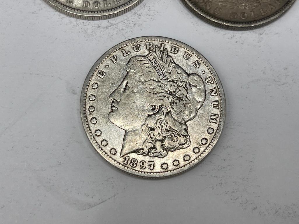 FIVE ASSORTED U.S. MORGAN SILVER DOLLARS