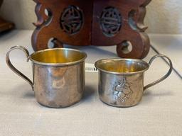 EARLY 20TH CENTURY STERLING SILVER BABY CUPS ONE WITH REPOUSSE FRUIT DESIGN EACH WITH HALLMARK