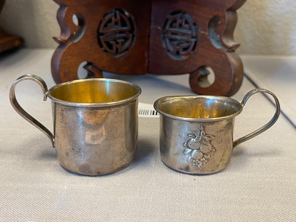 EARLY 20TH CENTURY STERLING SILVER BABY CUPS ONE WITH REPOUSSE FRUIT DESIGN EACH WITH HALLMARK