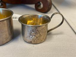 EARLY 20TH CENTURY STERLING SILVER BABY CUPS ONE WITH REPOUSSE FRUIT DESIGN EACH WITH HALLMARK