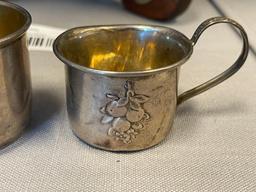 EARLY 20TH CENTURY STERLING SILVER BABY CUPS ONE WITH REPOUSSE FRUIT DESIGN EACH WITH HALLMARK