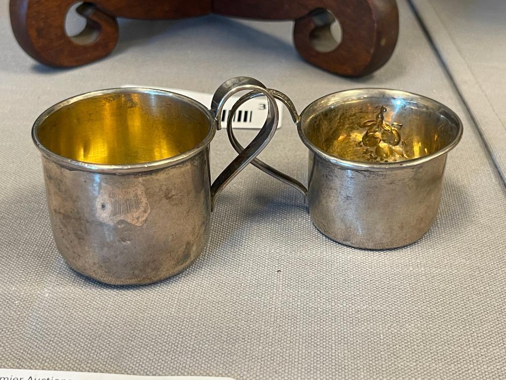 EARLY 20TH CENTURY STERLING SILVER BABY CUPS ONE WITH REPOUSSE FRUIT DESIGN EACH WITH HALLMARK
