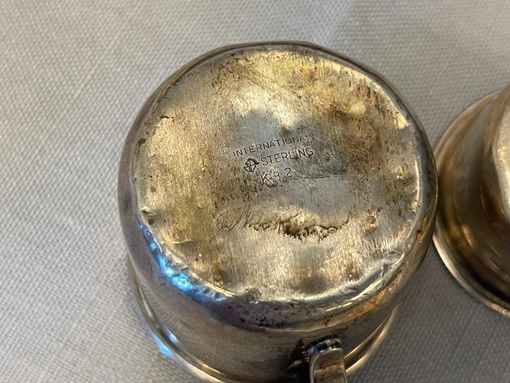 EARLY 20TH CENTURY STERLING SILVER BABY CUPS ONE WITH REPOUSSE FRUIT DESIGN EACH WITH HALLMARK