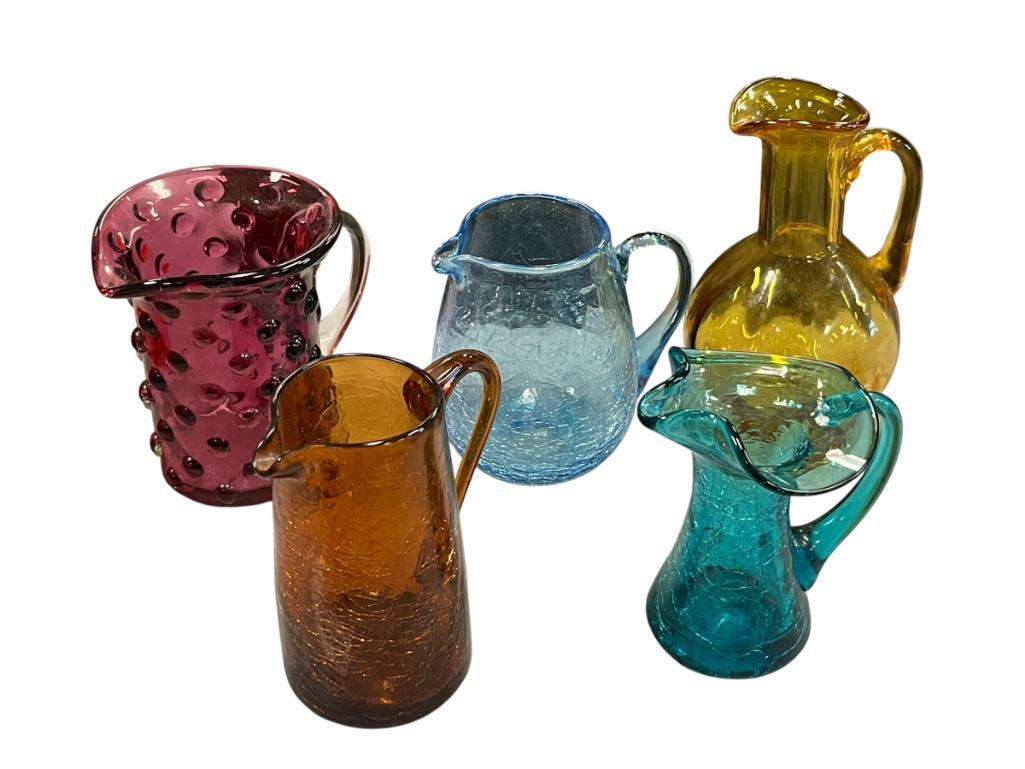FIVE HAND BLOWN ART GLASS SMALL PITCHERS IN VARIOUS COLORS AND STYLES, RUFFLED RIM, CRACKLED GLASS