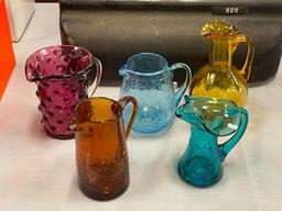 FIVE HAND BLOWN ART GLASS SMALL PITCHERS IN VARIOUS COLORS AND STYLES, RUFFLED RIM, CRACKLED GLASS