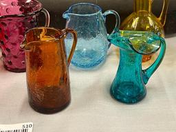 FIVE HAND BLOWN ART GLASS SMALL PITCHERS IN VARIOUS COLORS AND STYLES, RUFFLED RIM, CRACKLED GLASS