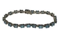 STERLING SILVER OVAL CUT BLUE TOPAZ TENNIS BRACELET