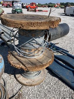 2 wooden wire spools with some wire