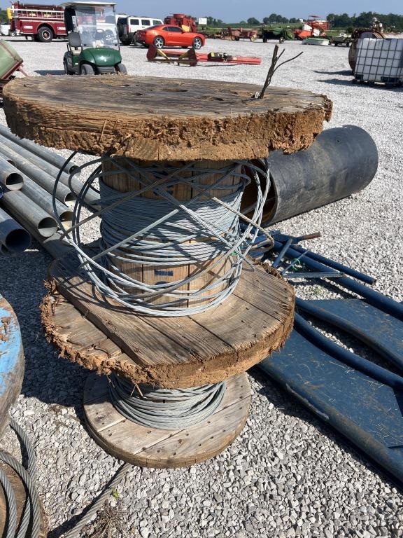 2 wooden wire spools with some wire
