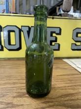 Green Embossed Glass Bottle â€“ T.P. Buck, Utterworth