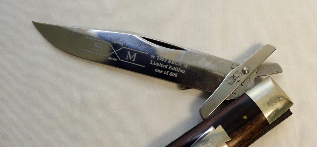 (2) KNIVES A CASE  MUSKRAT 1993 ABCA 1/800 STAG HANDLED FOLDING KNIFE AND A SXM 1993