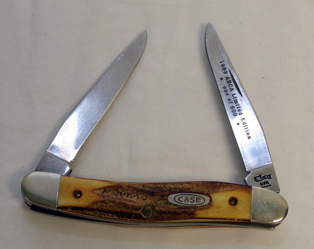(2) KNIVES A CASE  MUSKRAT 1993 ABCA 1/800 STAG HANDLED FOLDING KNIFE AND A SXM 1993